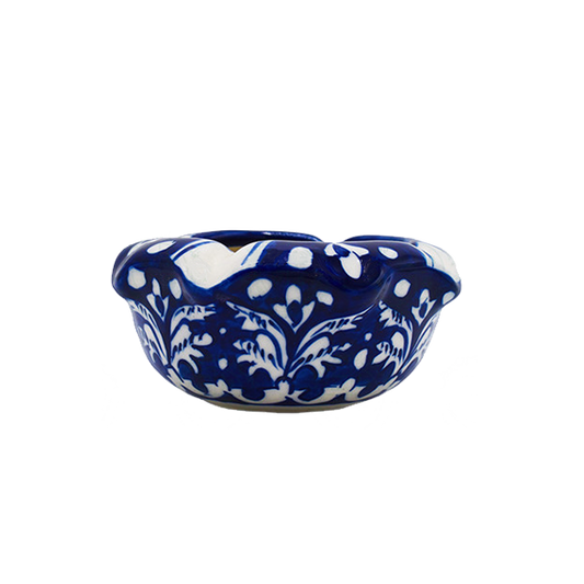 Blue and white ceramic ash tray with floral patterns on a white background