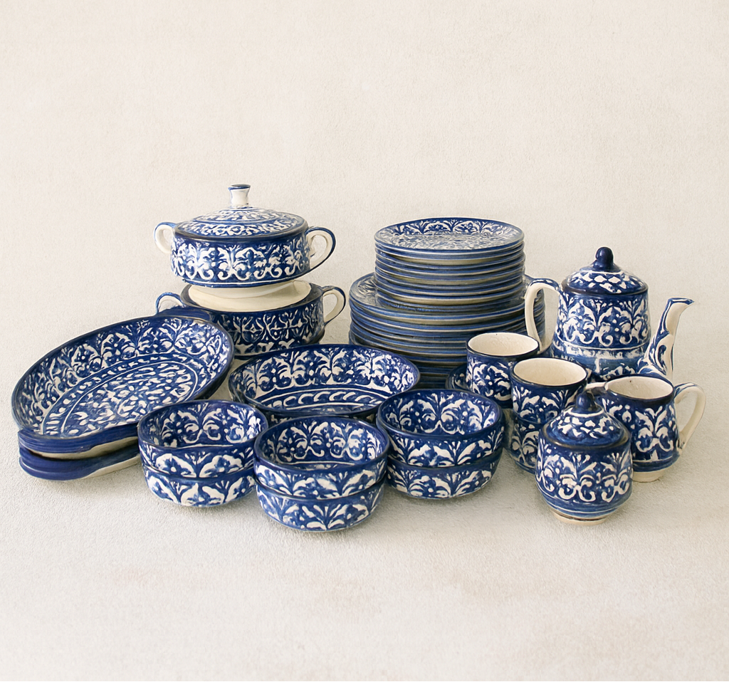 Collection of blue and white ceramic dishes on a beige background