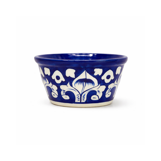 Blue ceramic ketchup bowl with white floral patterns on a white background