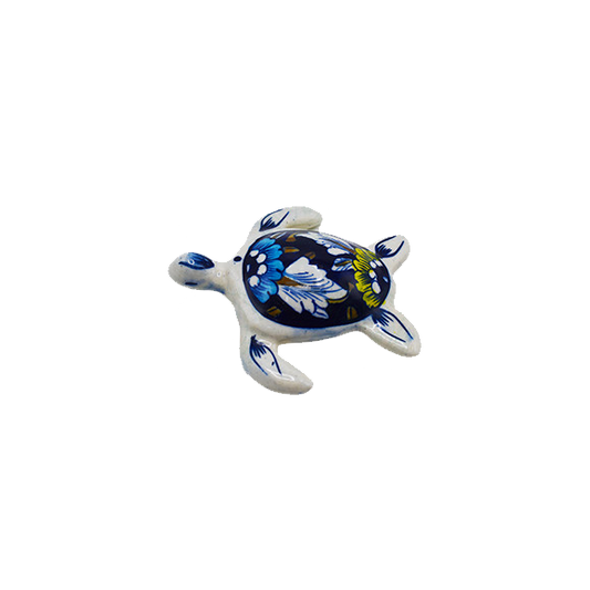 Decorative turtle figurine with blue and white pattern on a white background